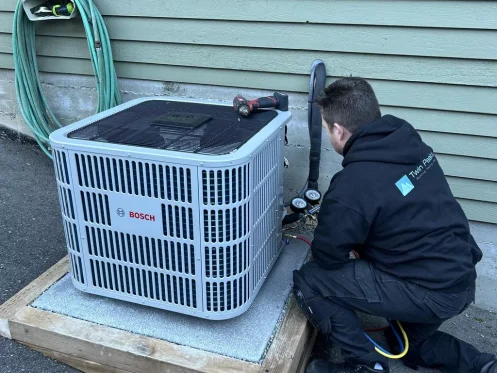 Twin Peaks tech inspecting heat pump